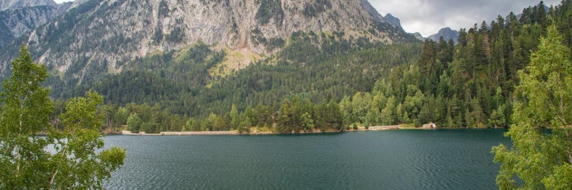 Beautiful landscape of Estany de Sant Maurici with Gran Encantat in the background, Catalonia, Spain.